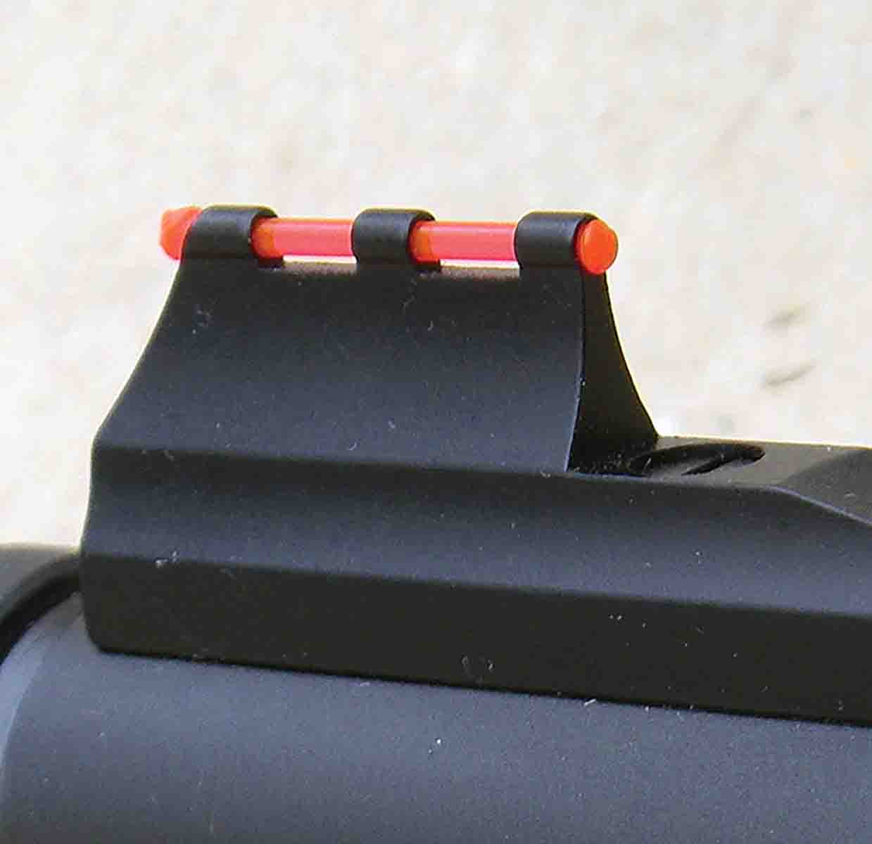 The front sight features a red fiber optic.